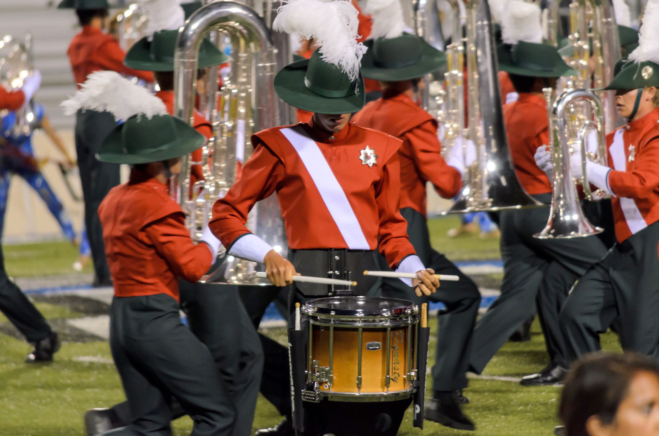 the marching band is dressed in red and black