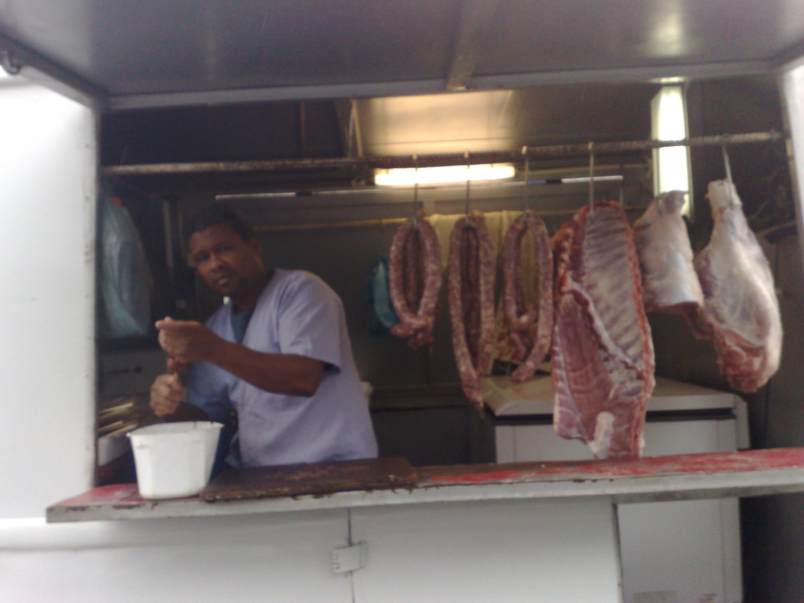 a butcher in his kitchen making cuts of meat