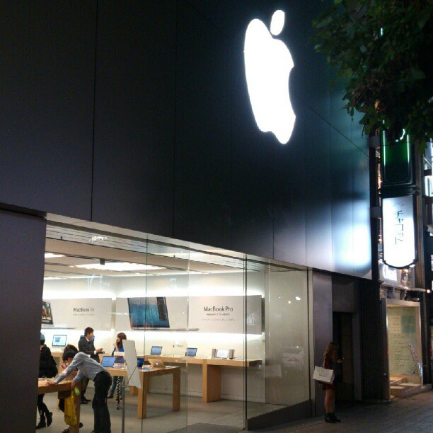 an apple store that has some people in it