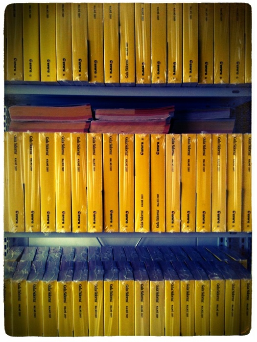 yellow books are sitting on shelves in a liry