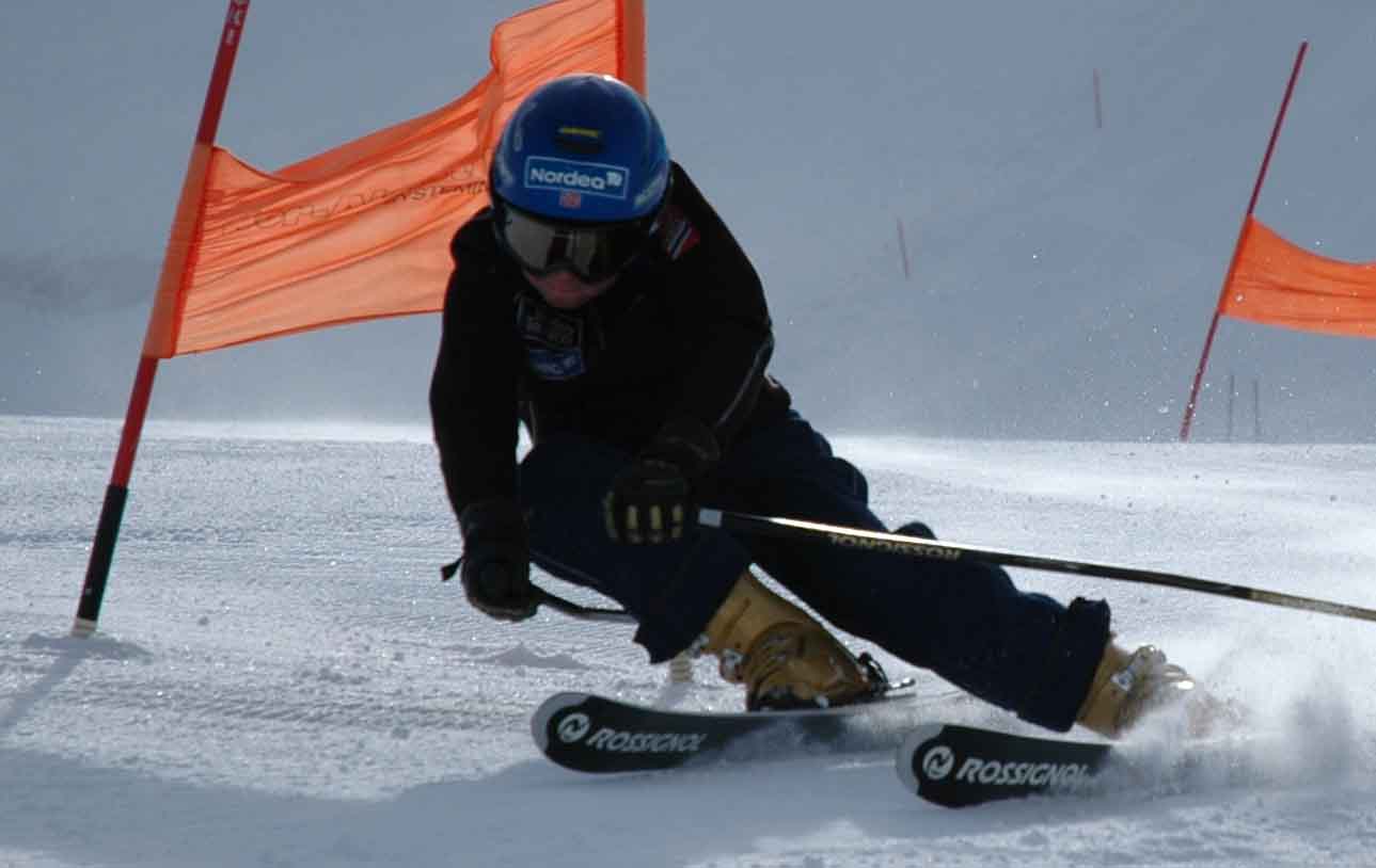 a person riding skis down a snow covered slope