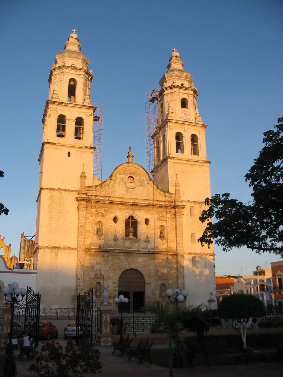 the tall church with clock tower are located at sunset