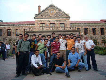 a group of people pose for a picture outside