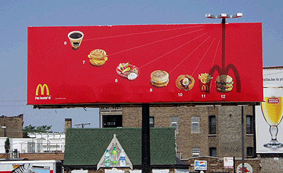 an advertising billboard in front of several buildings