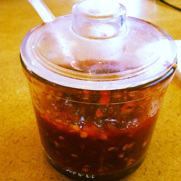 a jar filled with liquid and topped with spoon