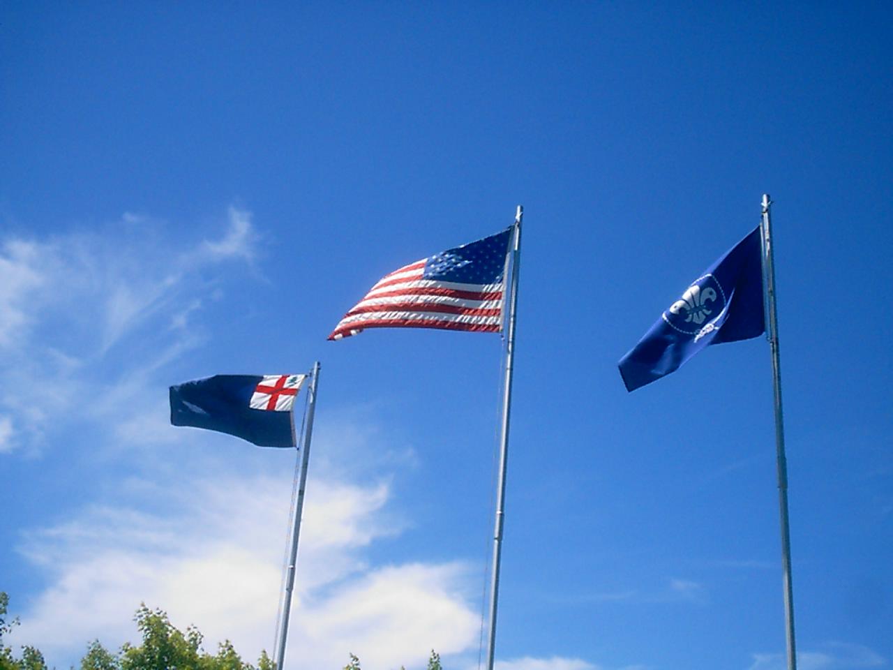 three different flags are flown in the air