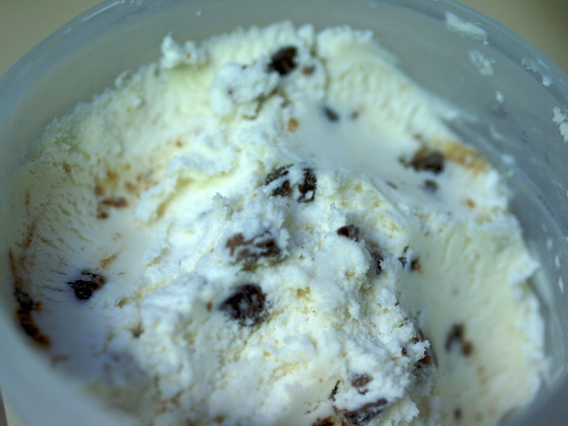a scoop of ice cream with raisins and chocolate in it
