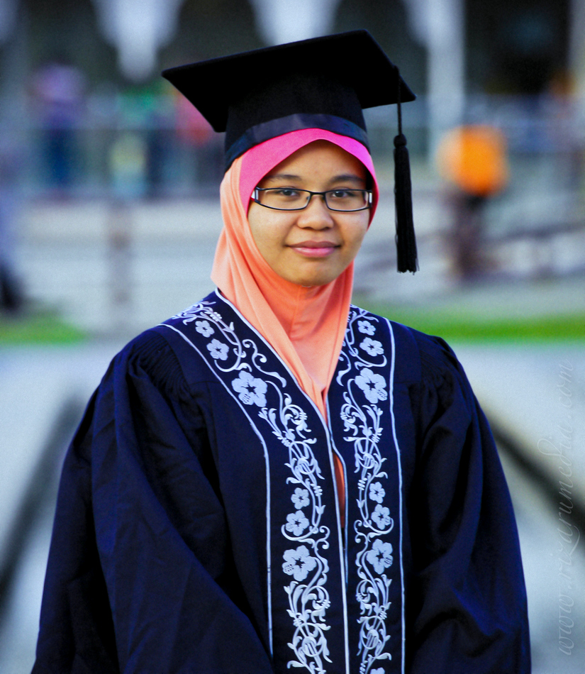 a woman wearing a graduation cap and gown