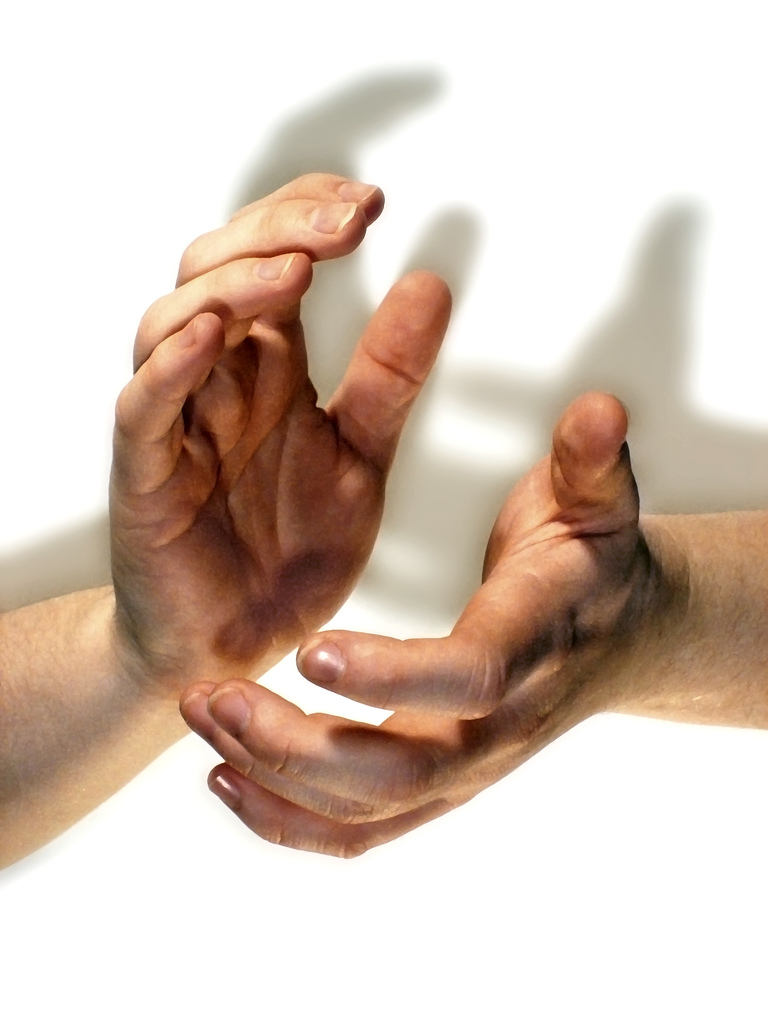 two hands extending upwards against each other