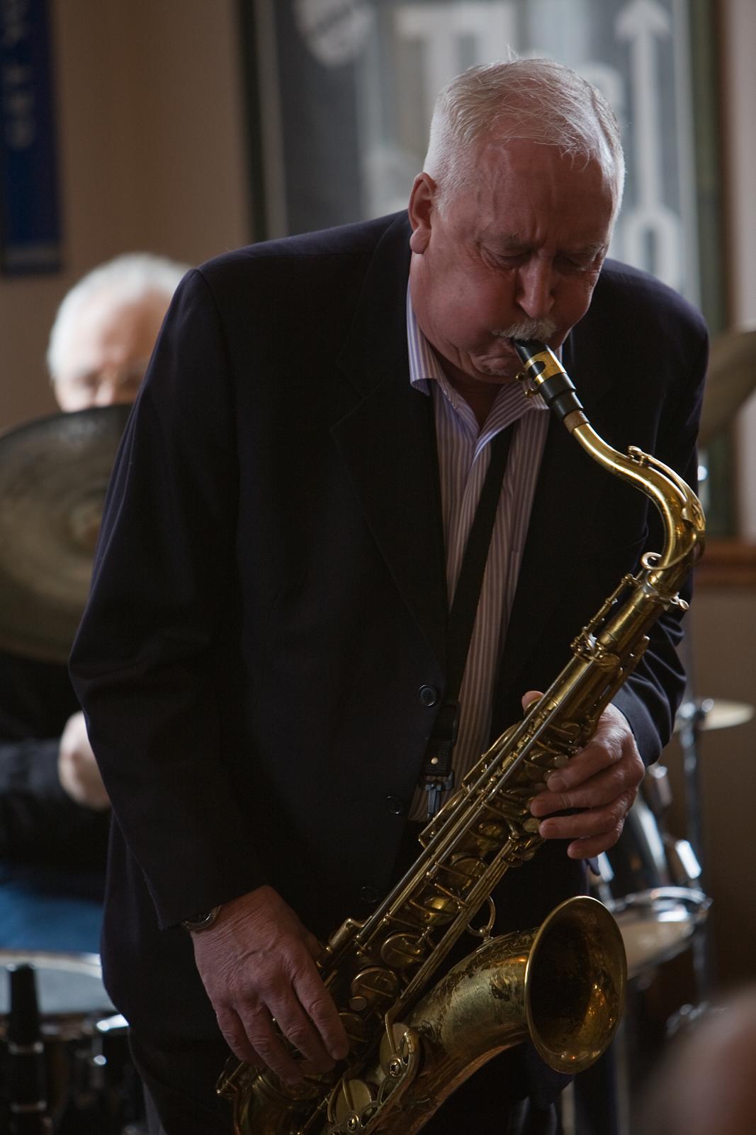 a man playing a saxophone on stage