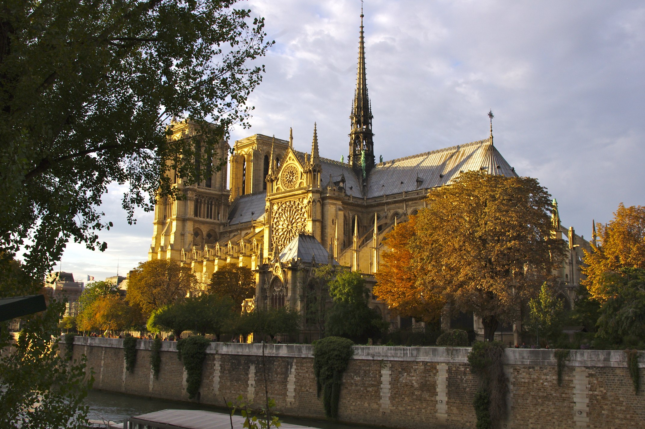 a tall cathedral with a spire surrounded by trees