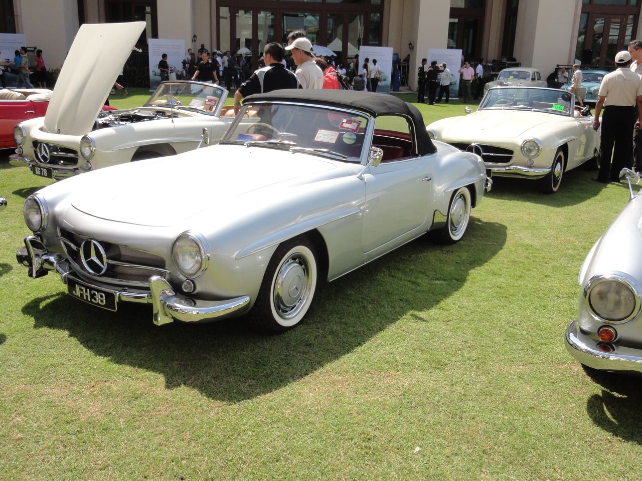 antique mercedess on display in the grass at a classic car show