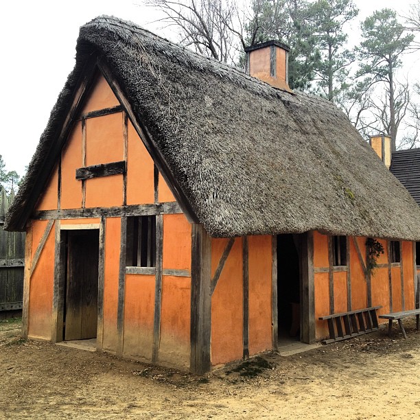 an orange building with a thatched roof