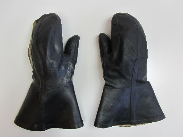 a pair of black leather gloves on a white surface