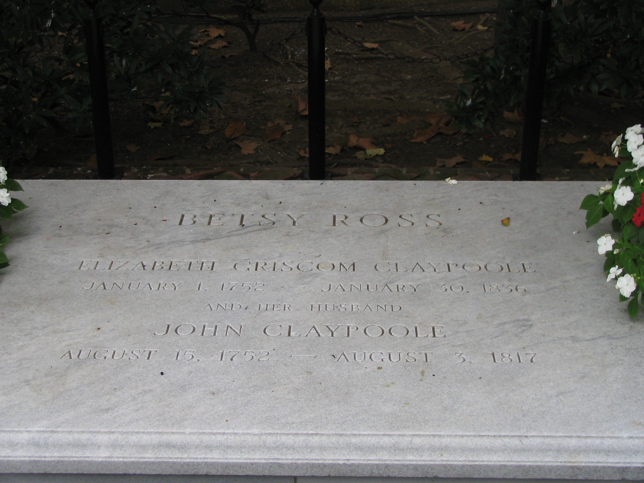 two flowers placed on the side of a monument