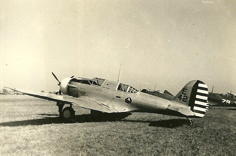 an old black and white po of a plane in the grass