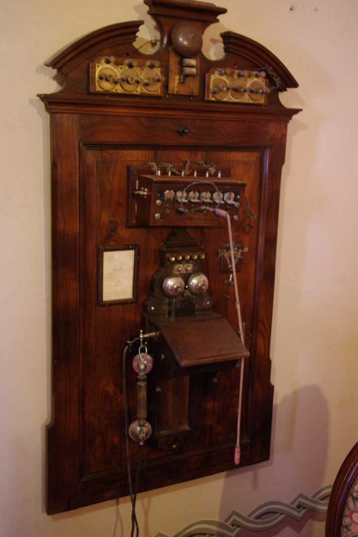 a wooden cabinet with many different decorations and items