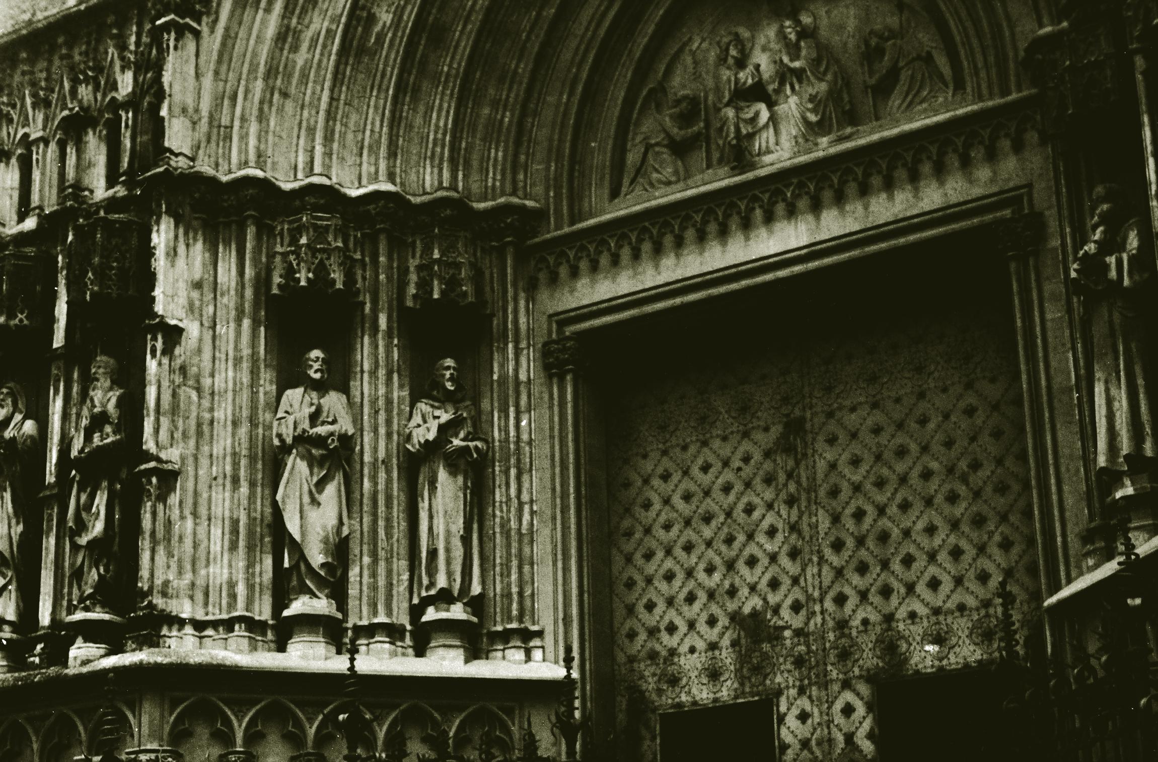 the sculpture of a woman next to some other statues