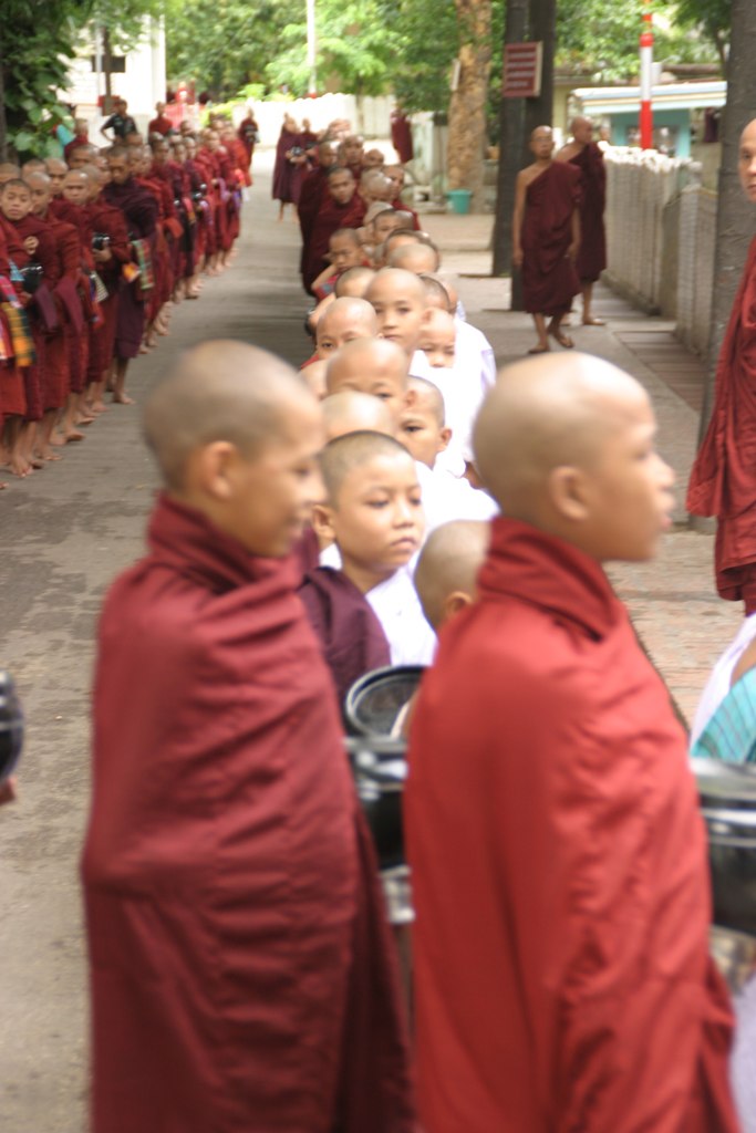a group of monks walking down a street