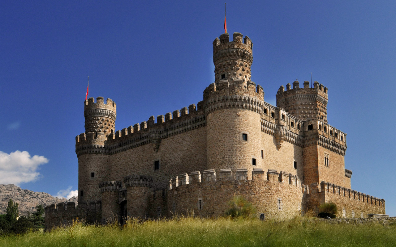 a big castle built on a hill side