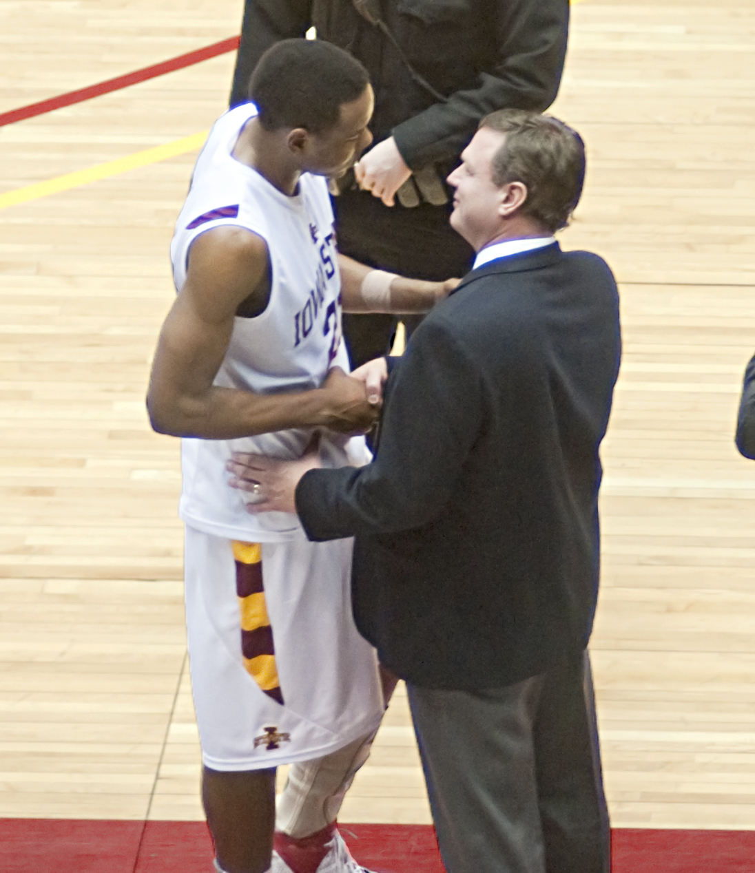 a man with an award on his right arm next to a person in a suit