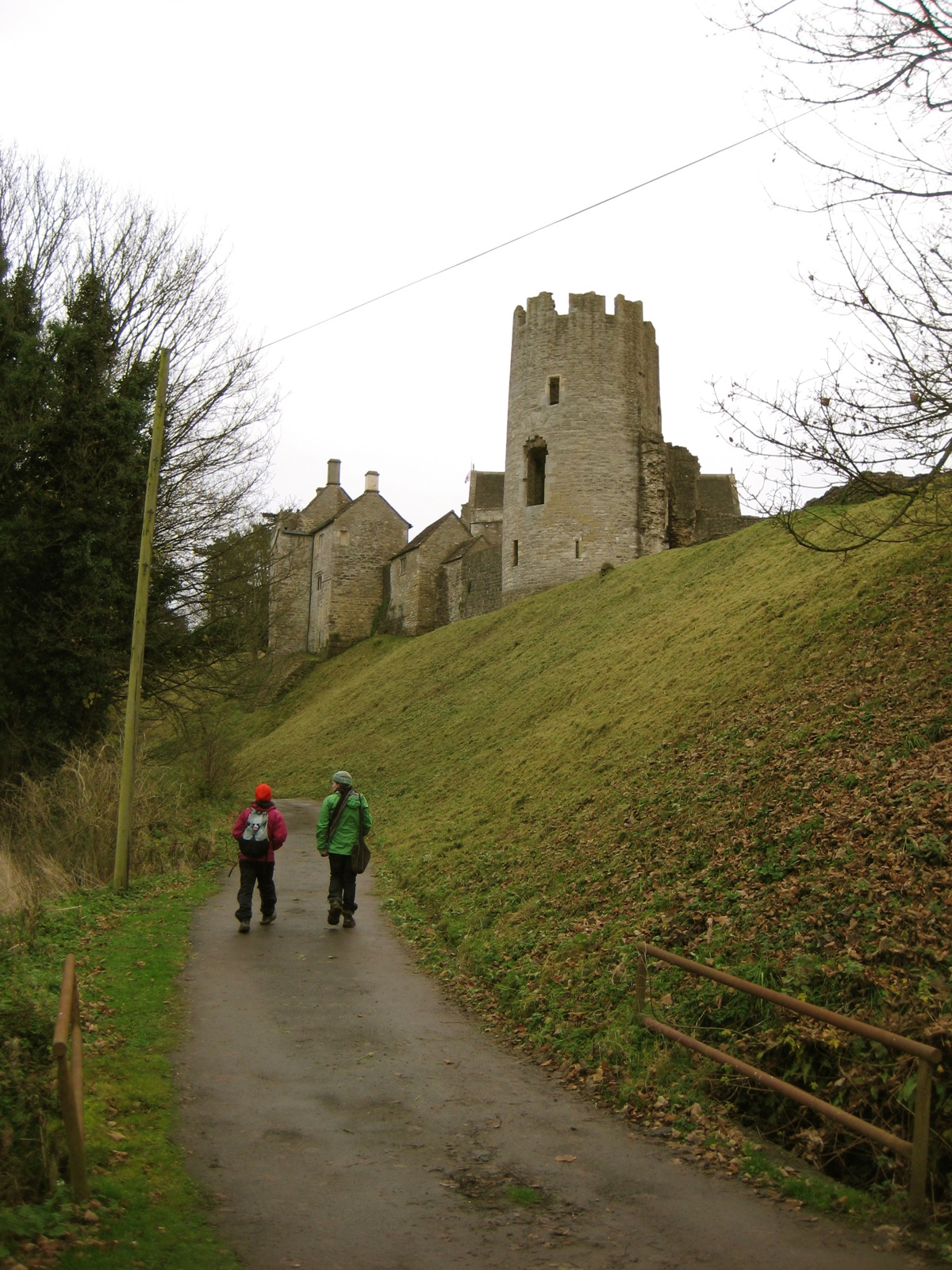 two people walk down the path towards a castle