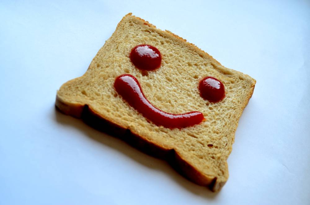 a toast with jam and a smile made from two slices of bread