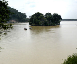 two boats are traveling on the river with brown water