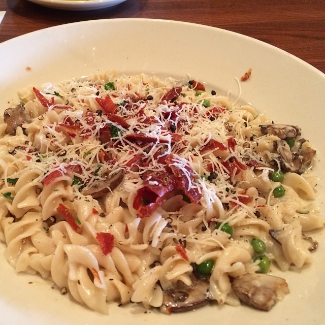 a bowl filled with pasta topped with toppings