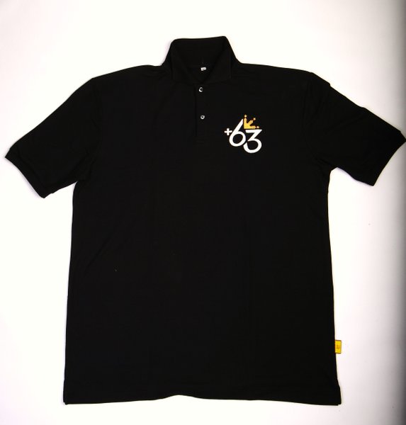 a polo shirt with a gold and white symbol on the chest