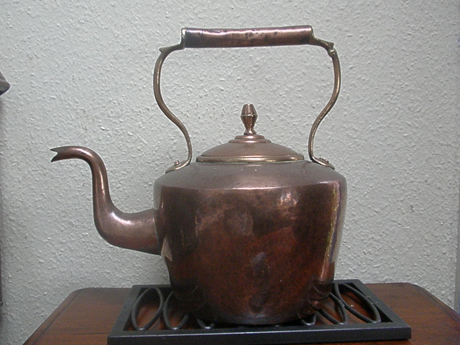 an antique tea pot on the stove top