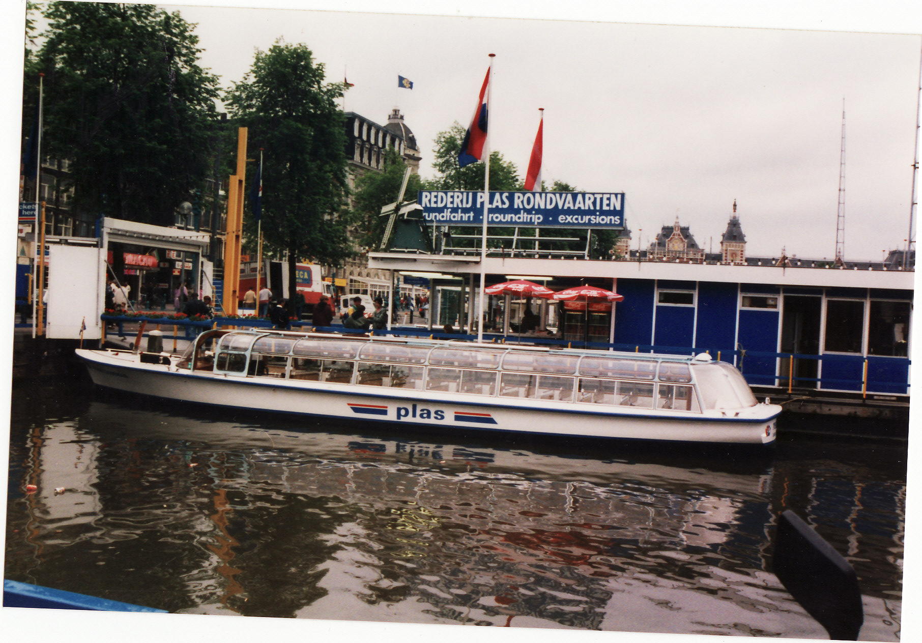 a white boat on water near buildings