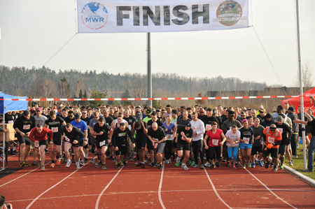 group of people starting a run on a race track