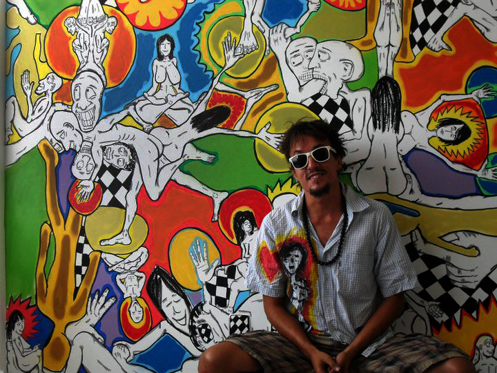 a man in front of a large multi colored wall