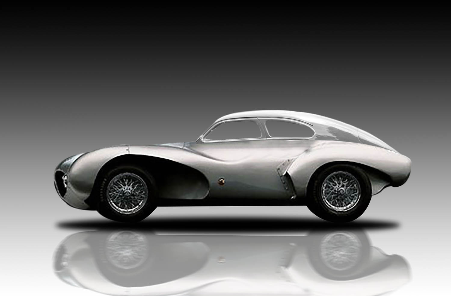 a silver vintage car with white walls and flooring