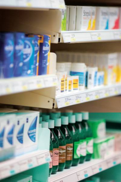 shelves with various medications in the aisle