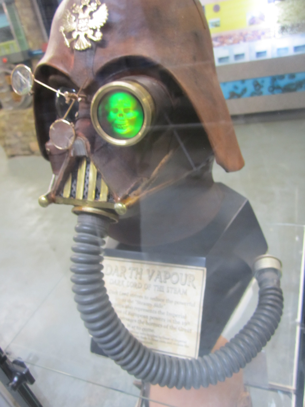 an antique gas mask is set inside a display case