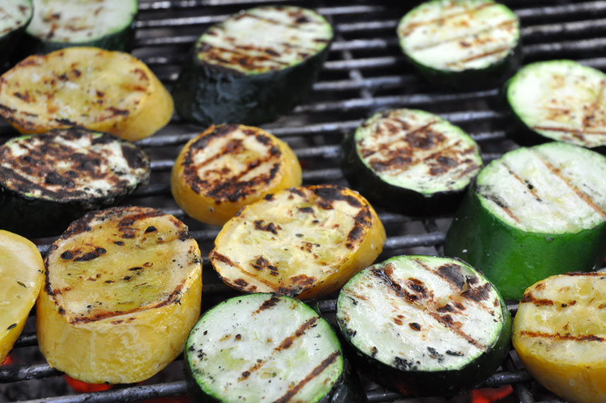 a barbecue grill filled with vegetables and grilled on top of it