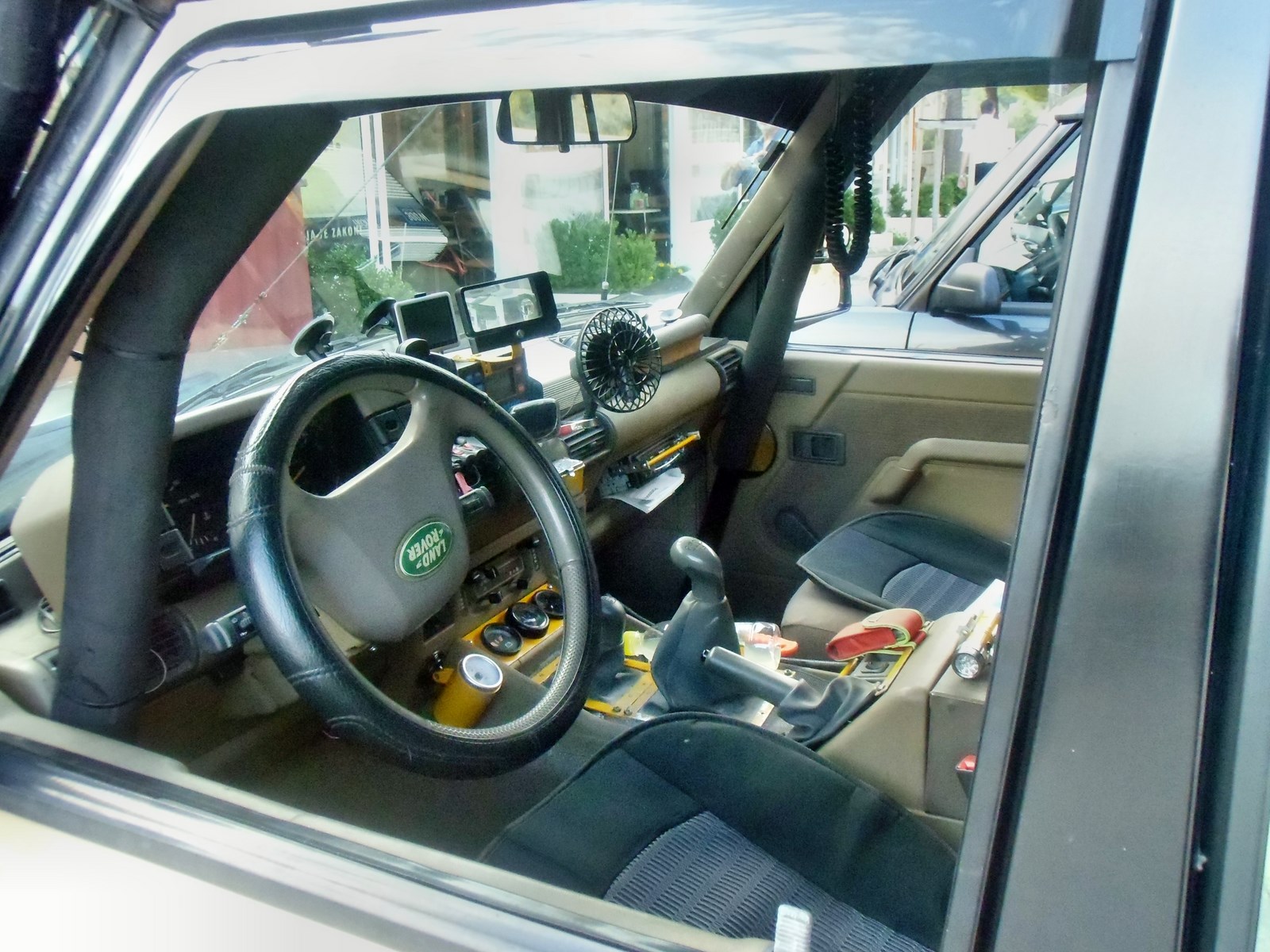 the car interior of a vehicle with many items in it