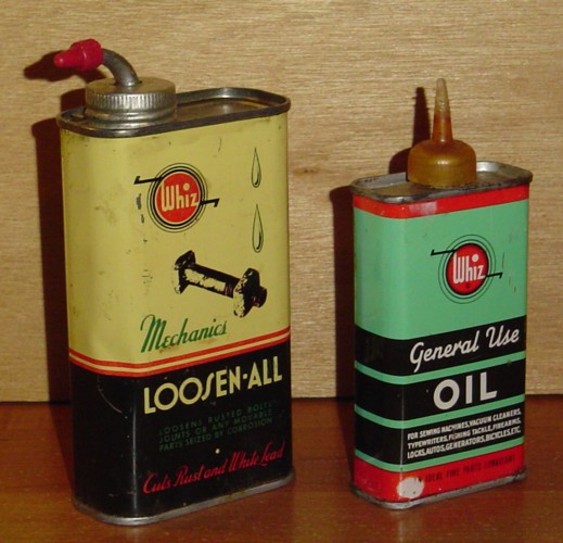 two old oil cans are sitting on the table