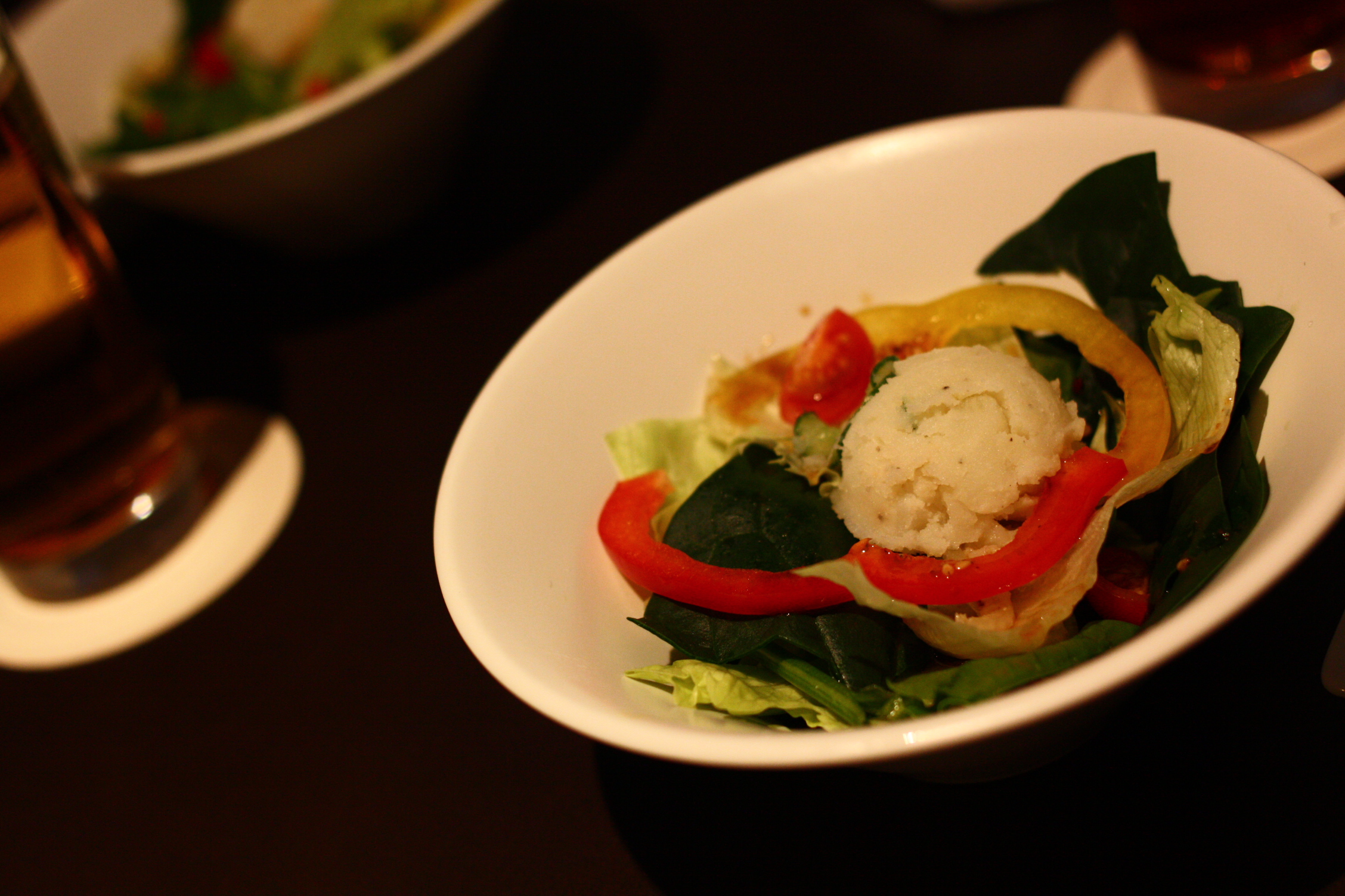 a white bowl full of food and vegetables on a table