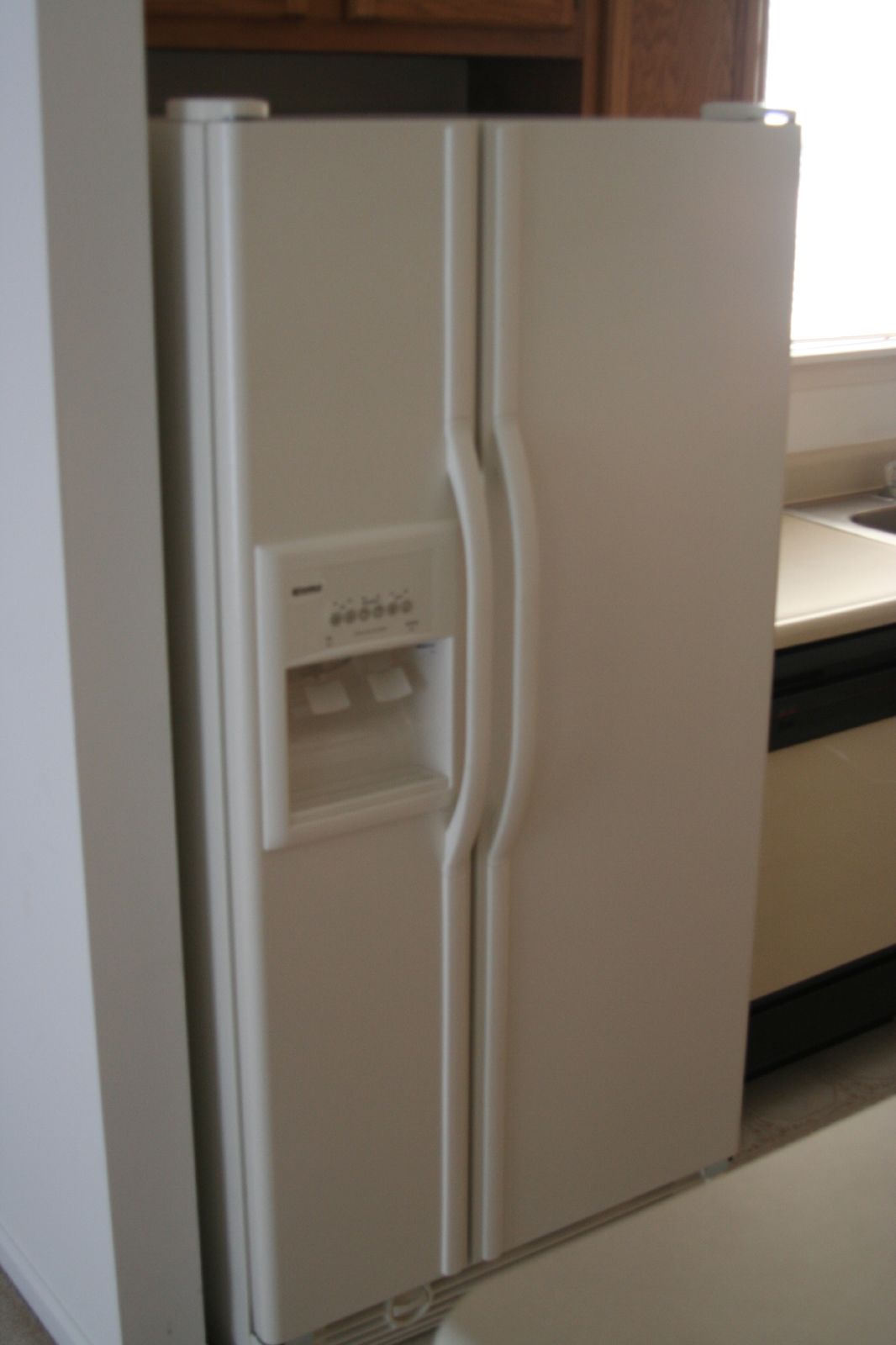 there is a small white refrigerator freezer on display