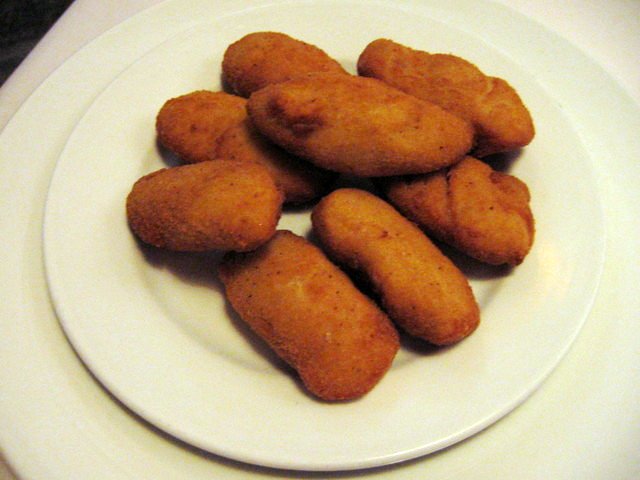 there are many breaded bites arranged on the plate