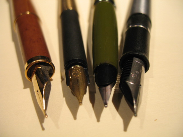pens and a pen resting on a surface