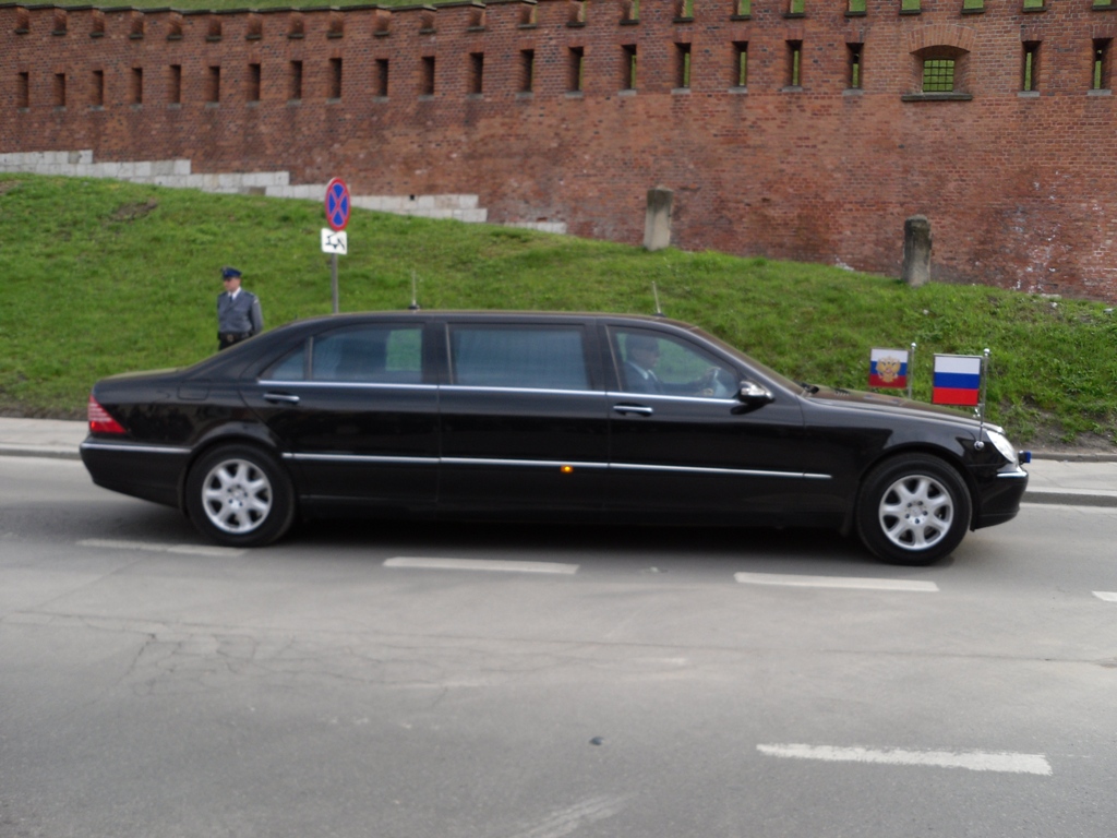 a black car is parked on the side of the road