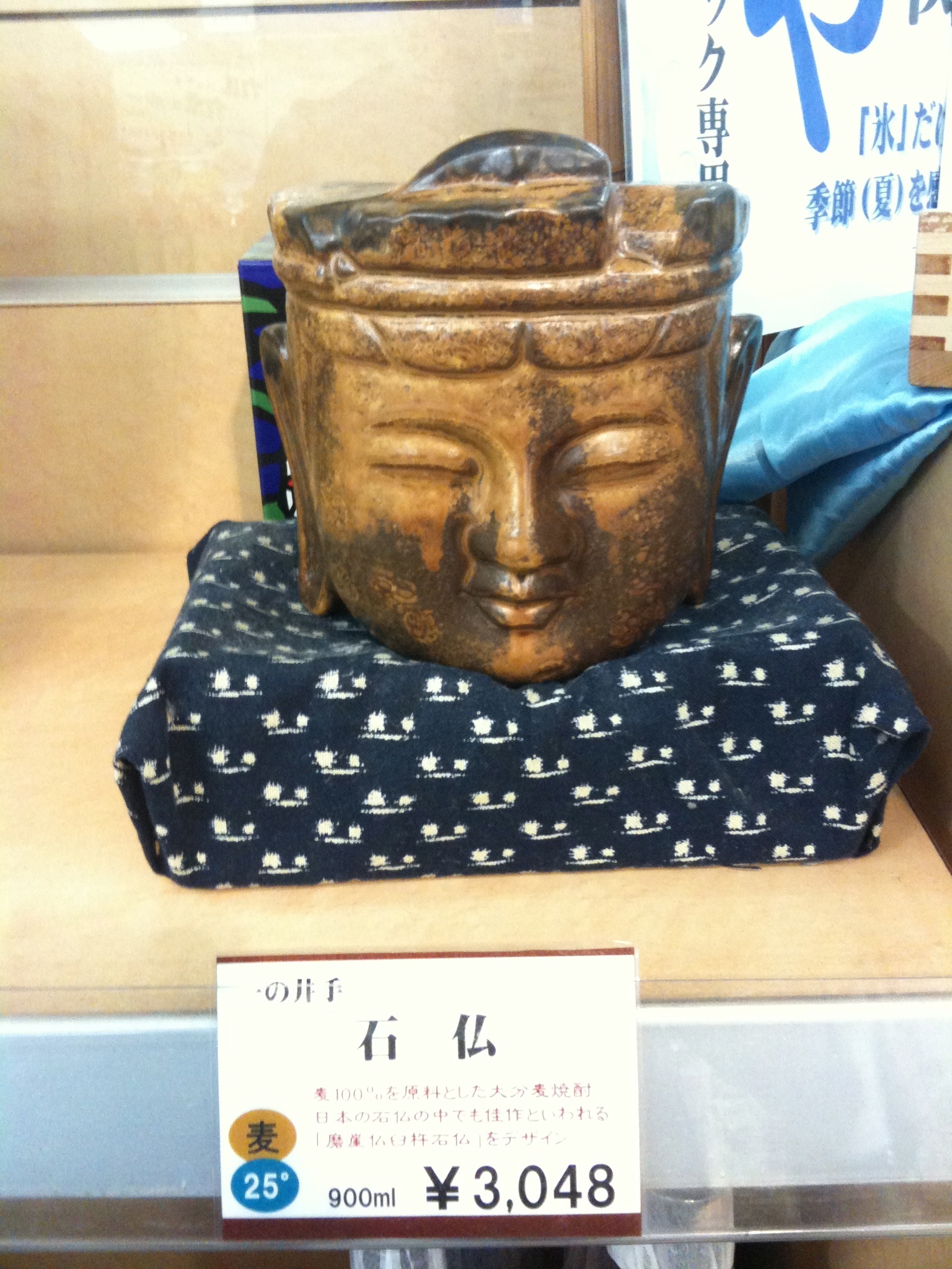 a small wooden buddha statue sitting on top of a counter