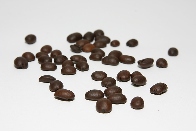 a pile of chocolate beans is shown scattered on the table