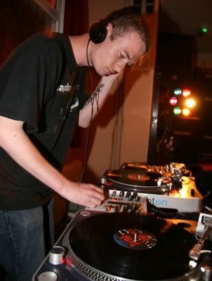 a man standing in front of a dj equipment