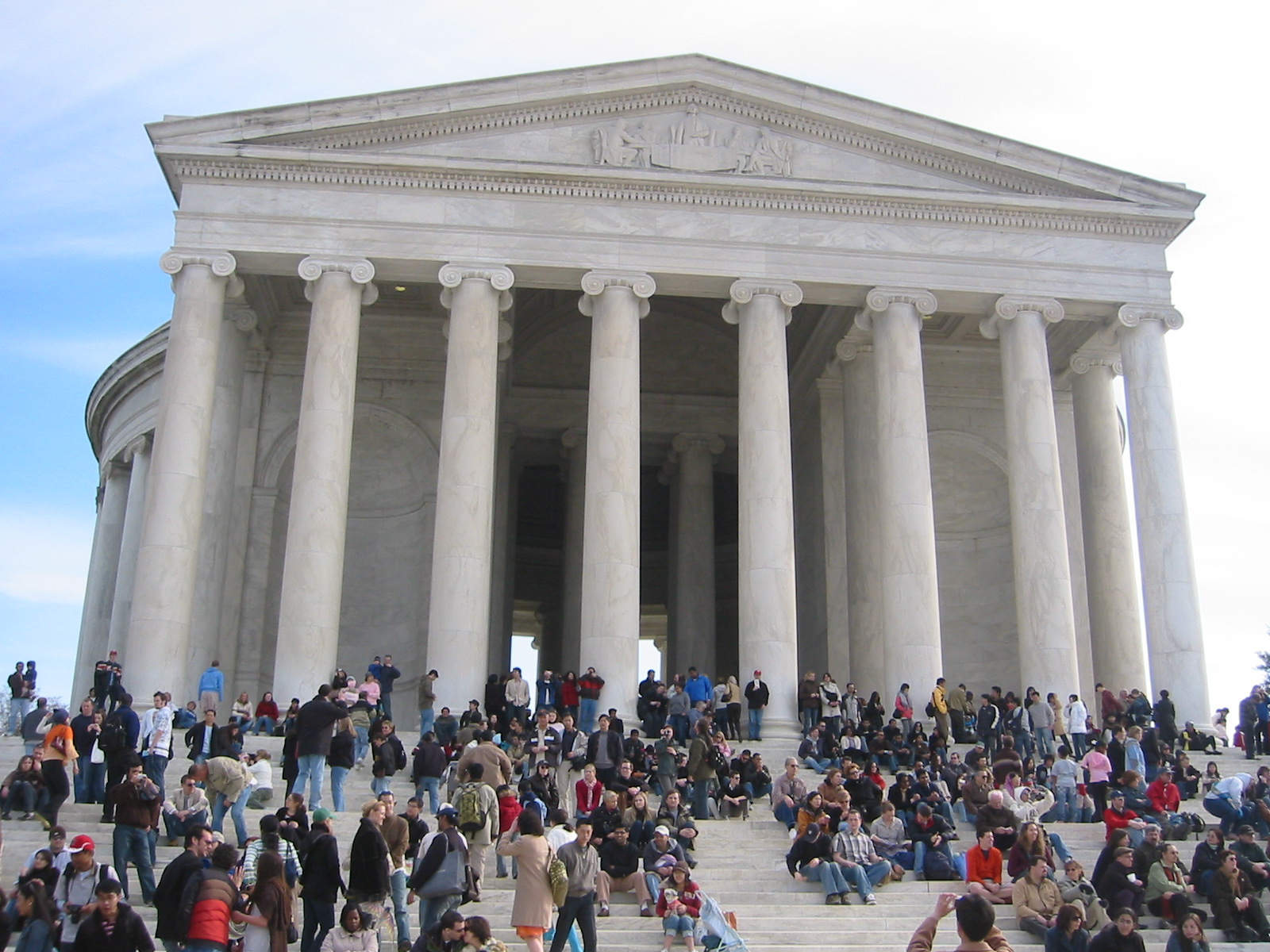 a crowd of people are outside of a building