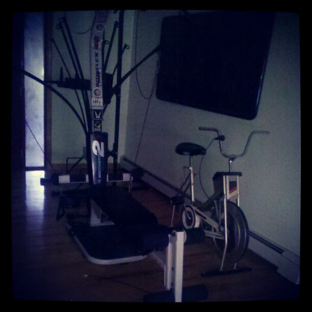 a gym with a bicycle and exercise equipment